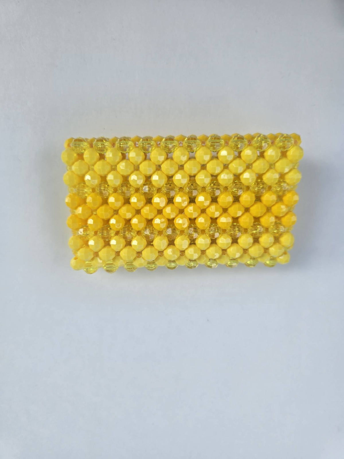 A rectangular yellow beaded clutch or clutch bag made of faceted acrylic beads, shown on a plain light gray background.