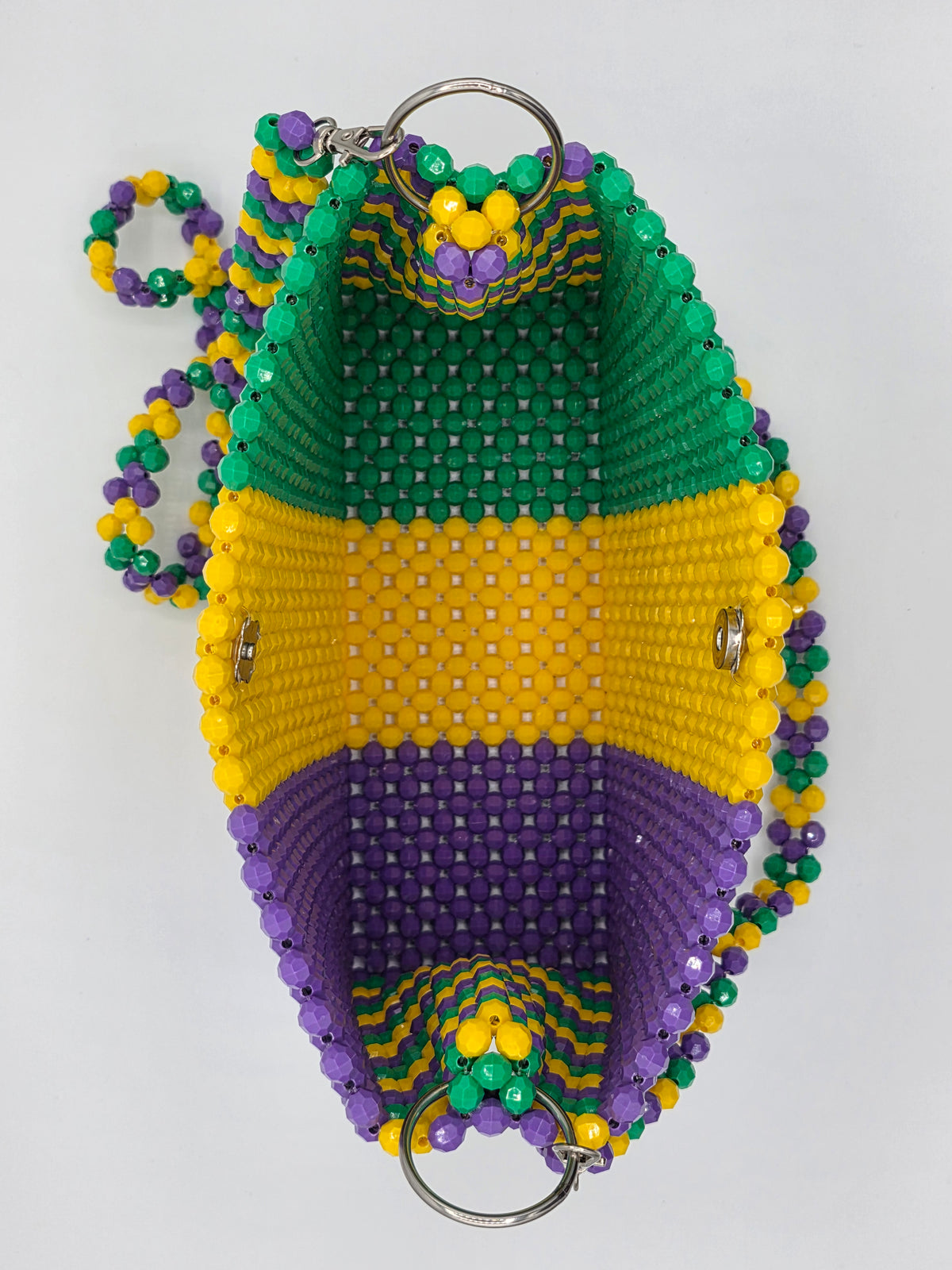 Showing how roomy this crossbody beaded mardi gras bag is.